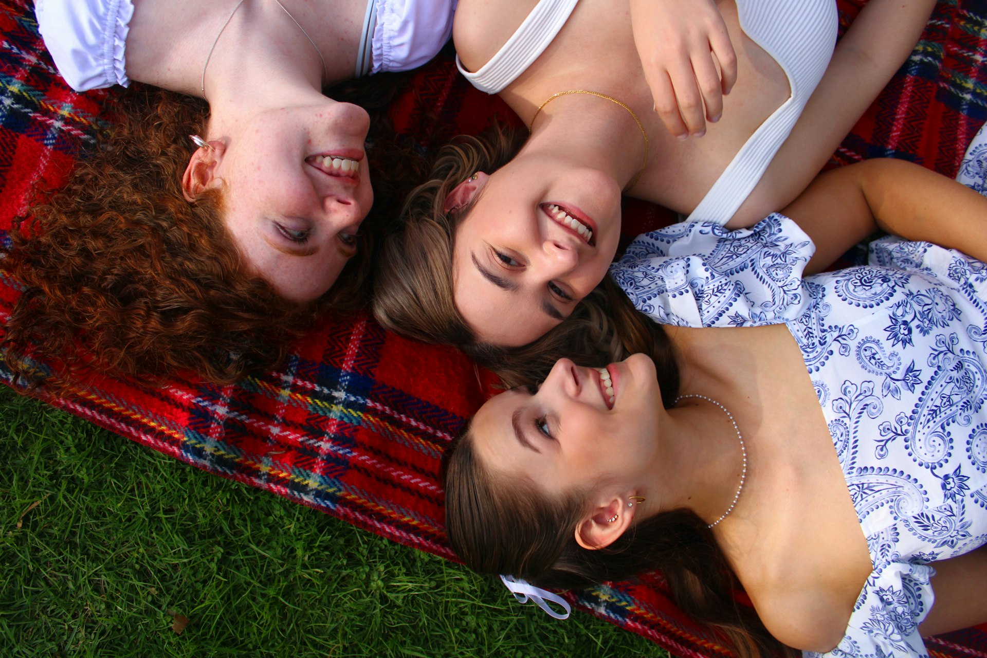 A group of people laying on top of a blanket